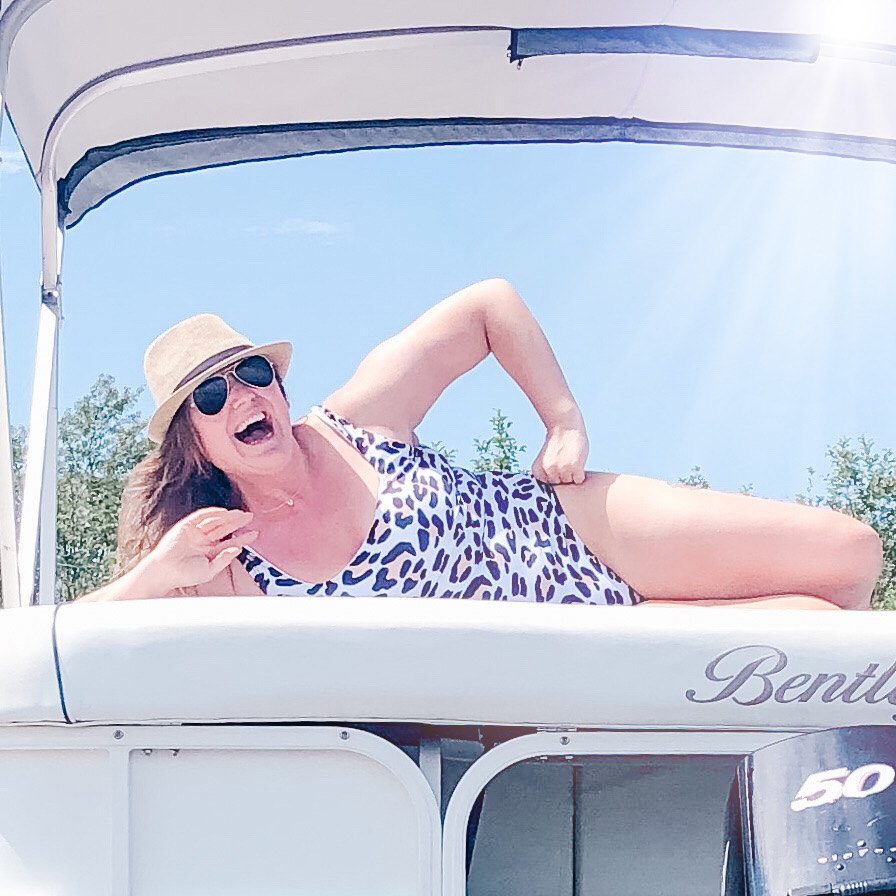 girl on a boat feeling confident in a leopard print bathing suit