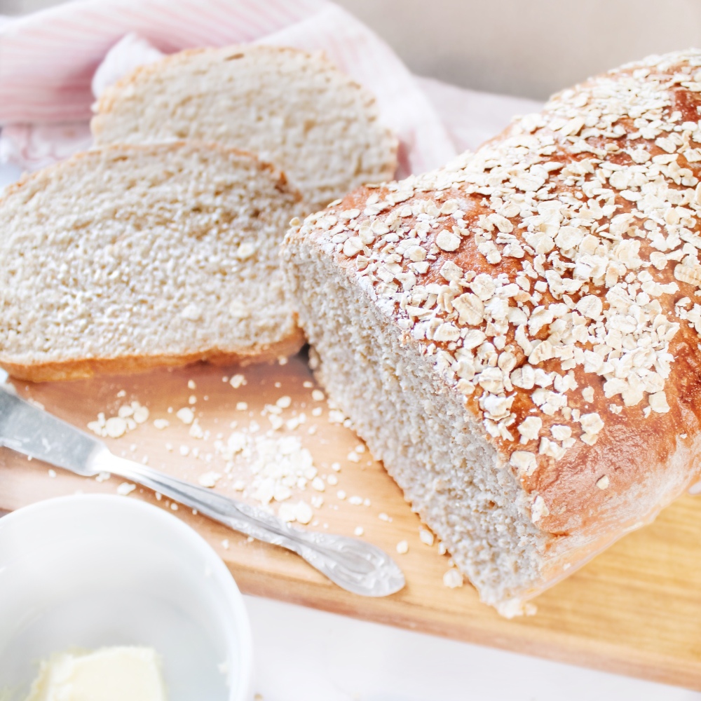 Best Whole Wheat Oats and Honey Bread Recipe - hearty whole wheat bread with the sweet taste of honey tops with rolled oats